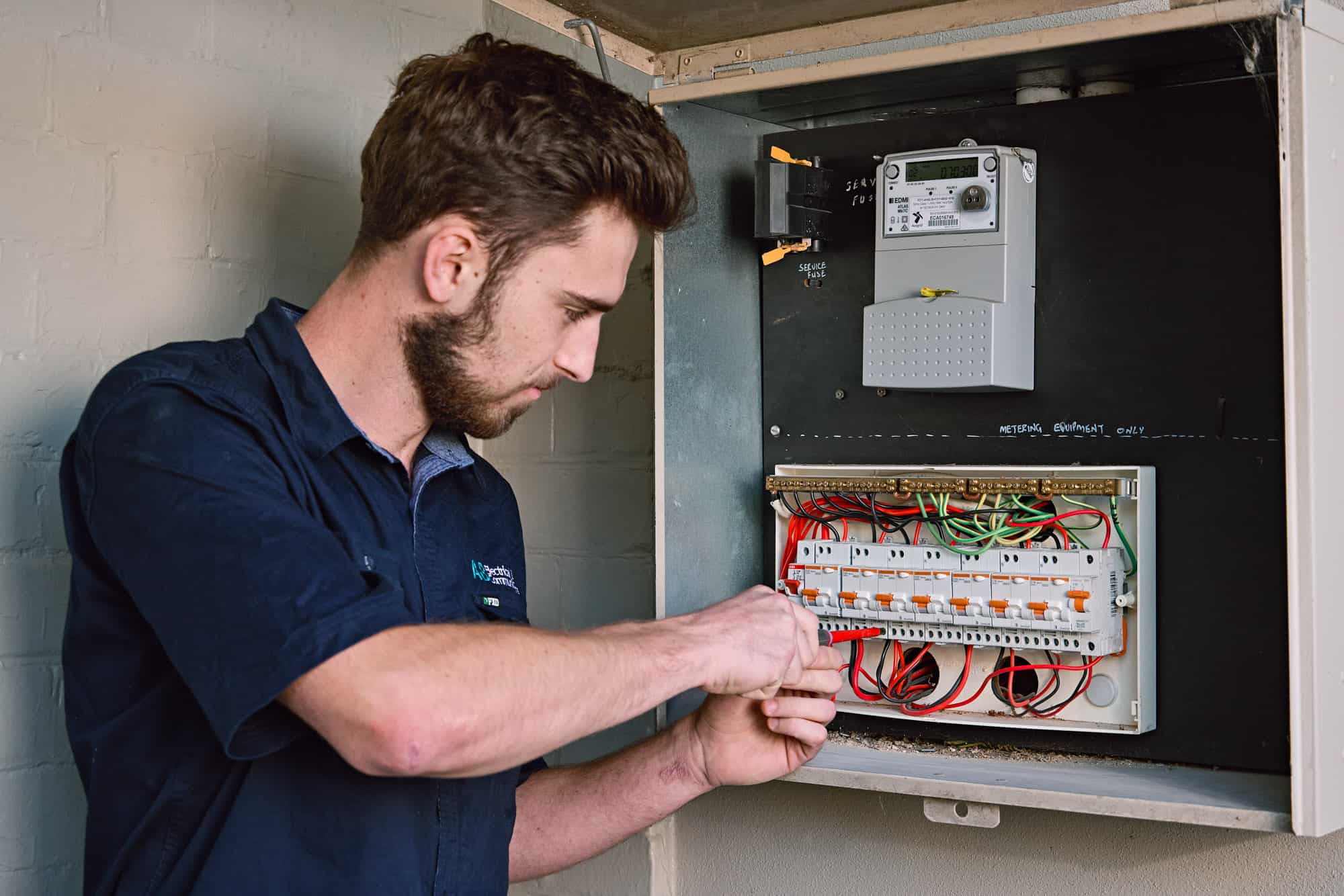 Licensed electrician working on switchboard